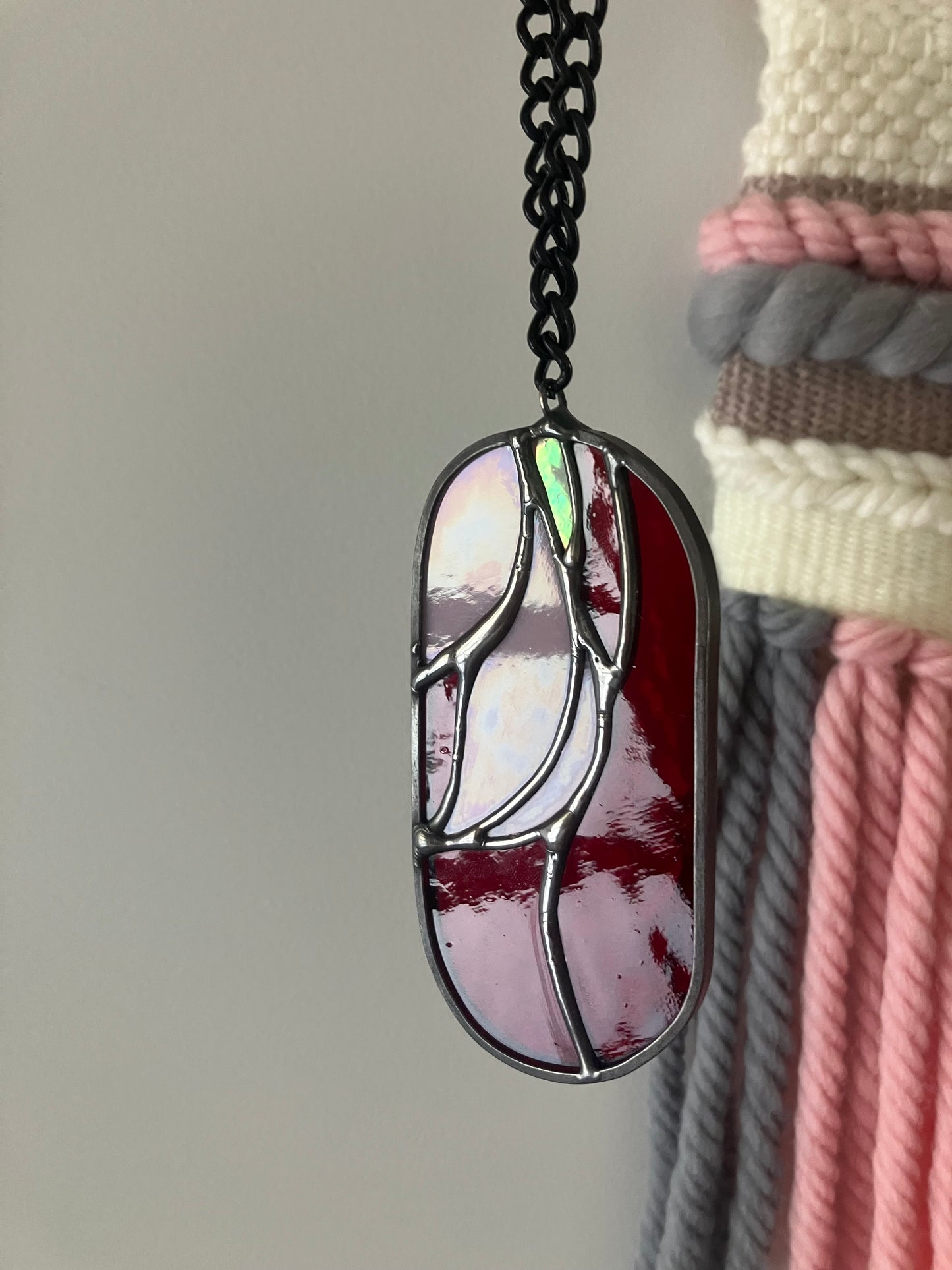 Wilted flower pill-shaped sun catcher - red and pink