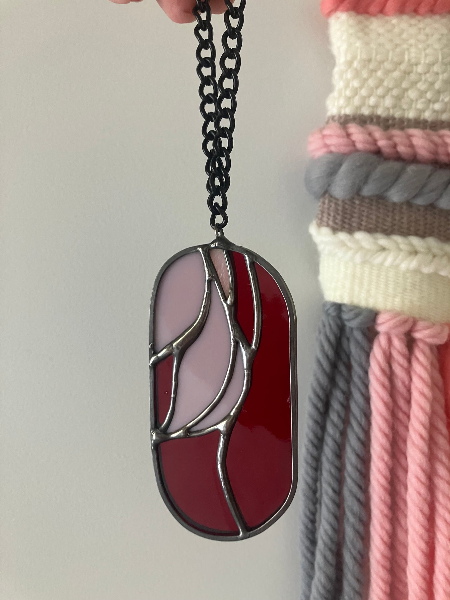 Wilted flower pill-shaped sun catcher - red and pink