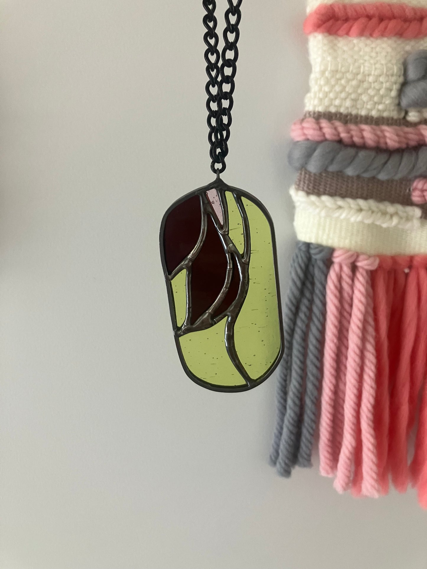 Wilted flower pill-shaped sun catcher - green, mauve and pink