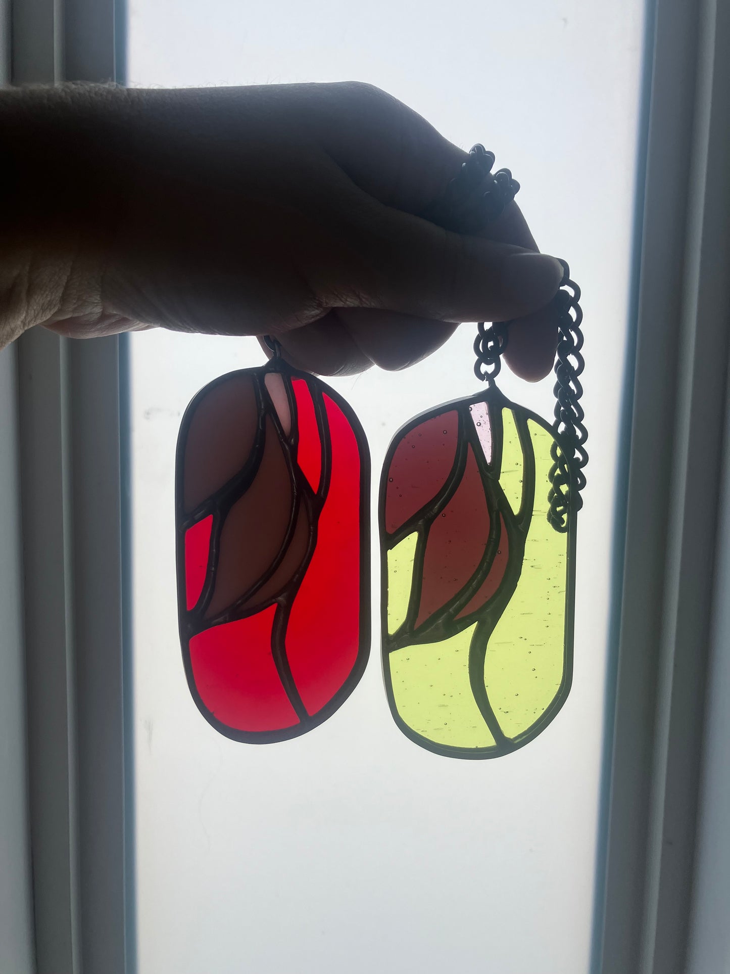 Wilted flower pill-shaped sun catcher - red and pink