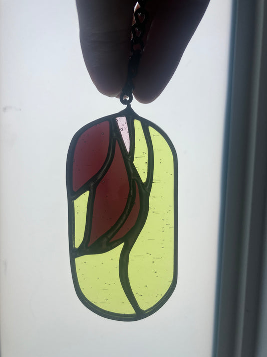 Wilted flower pill-shaped sun catcher - green, mauve and pink