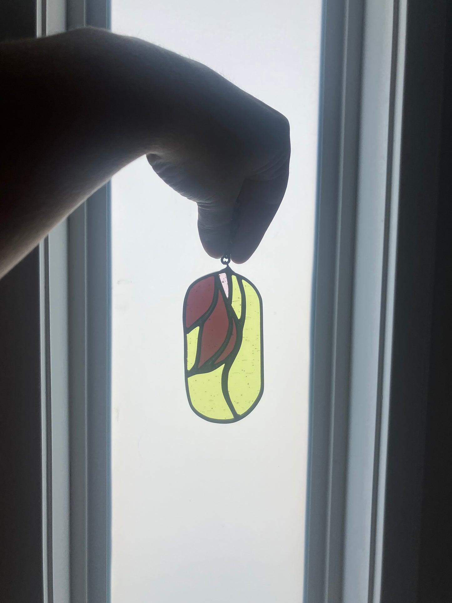 Wilted flower pill-shaped sun catcher - green, mauve and pink