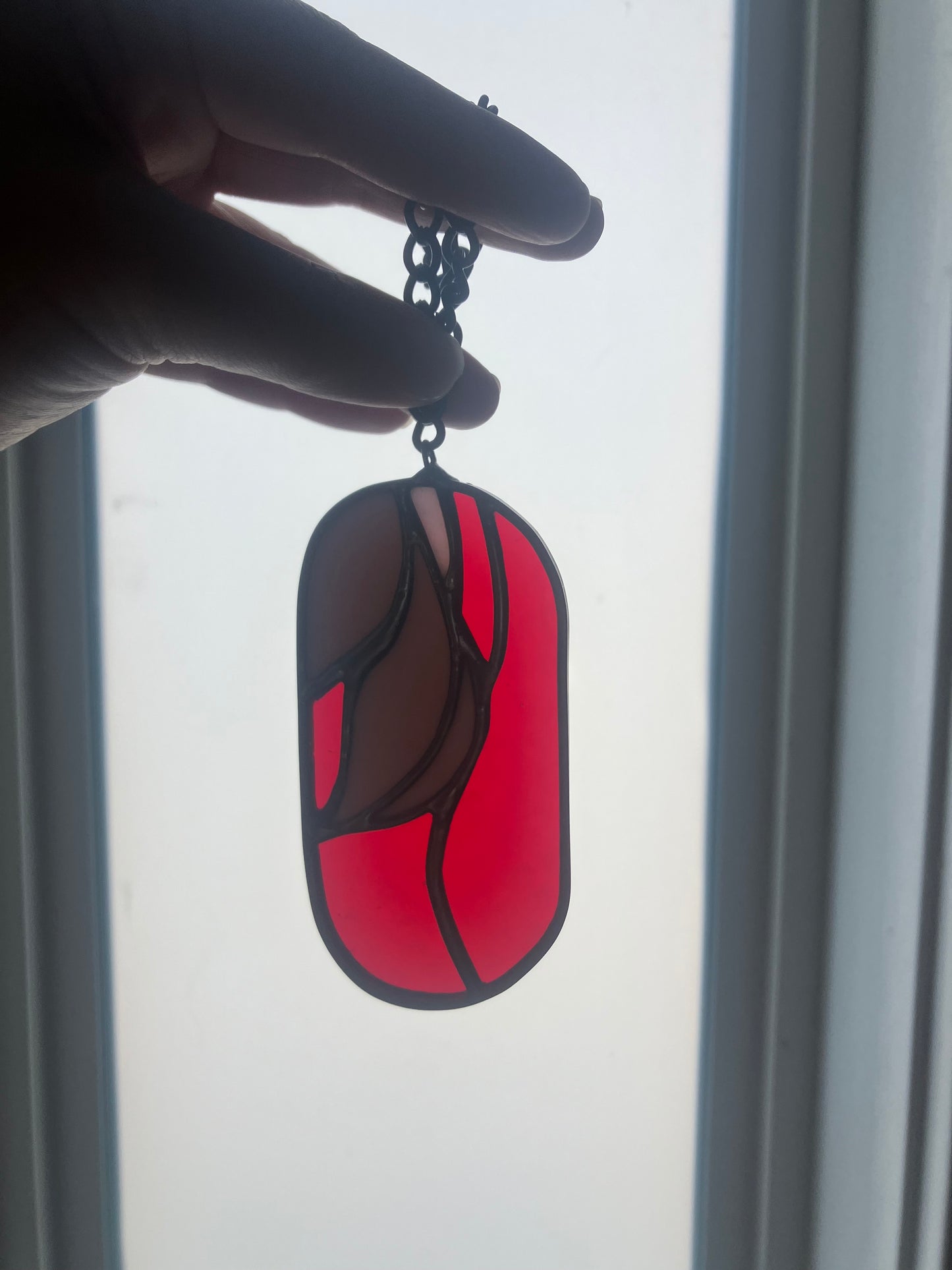 Wilted flower pill-shaped sun catcher - red and pink